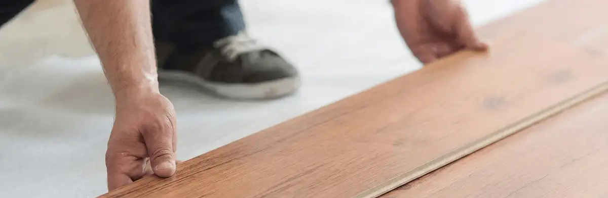 A professional installing laminate flooring in Springfield, MO